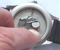 Battery retained by spring clip